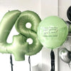 Green foil number balloons spelling out the number 4 and a round balloon