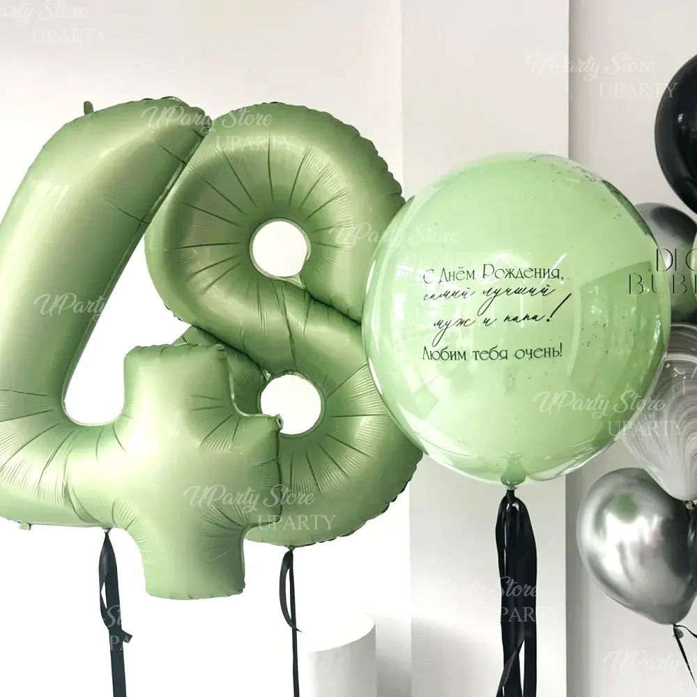 Green foil number balloons spelling out the number 4 and a round balloon