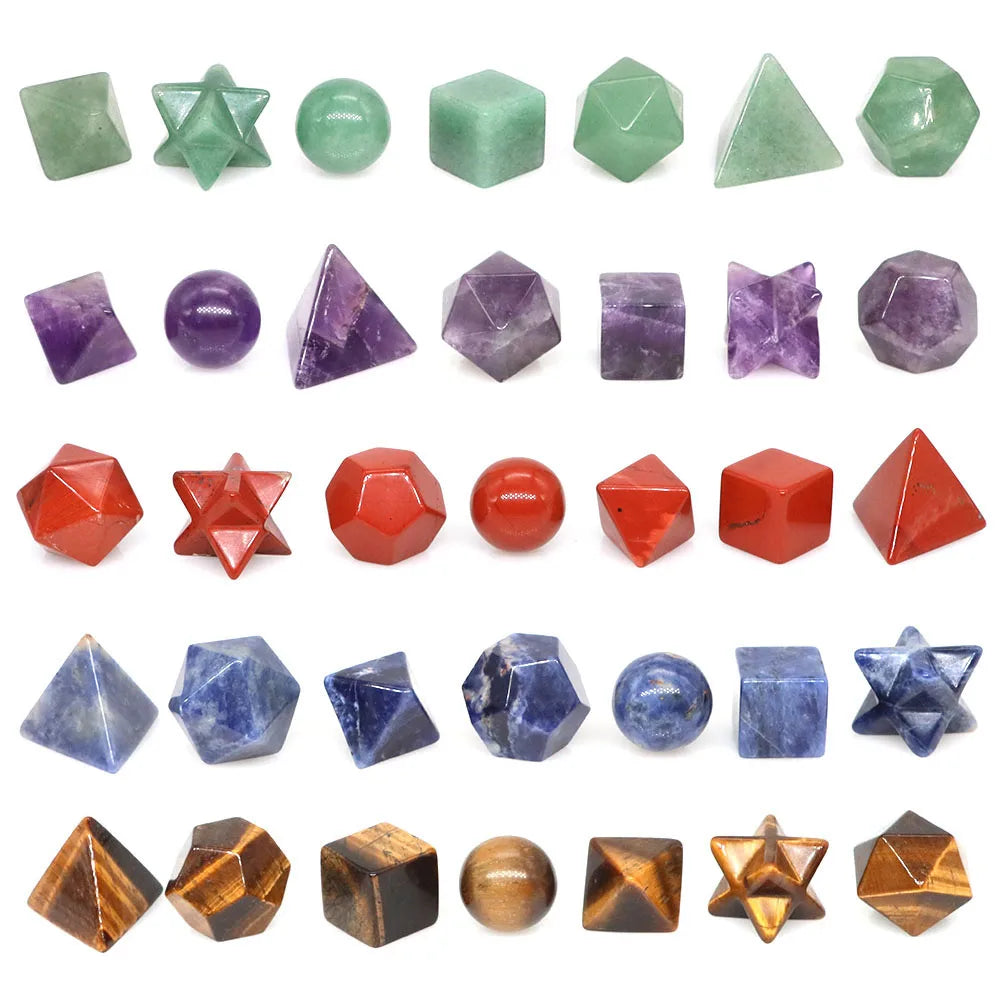 A collection of ten polished geometric crystals in various shades of green, purple, and red.
