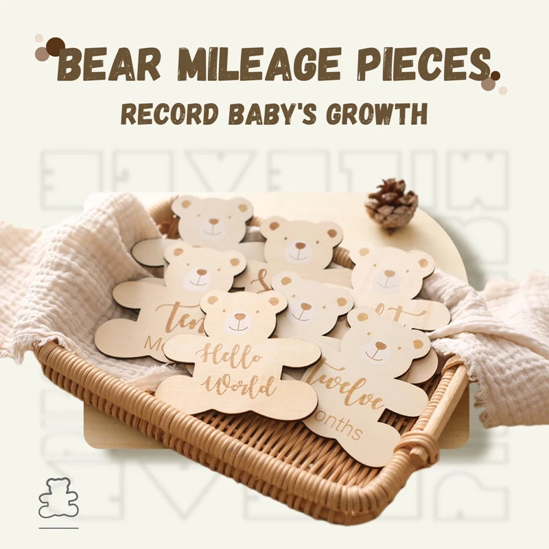 A set of wooden bear milestone cards for recording a baby's growth, featuring various months.