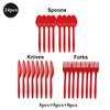 A set of red eating utensils including spoons, knives, and forks for a party.