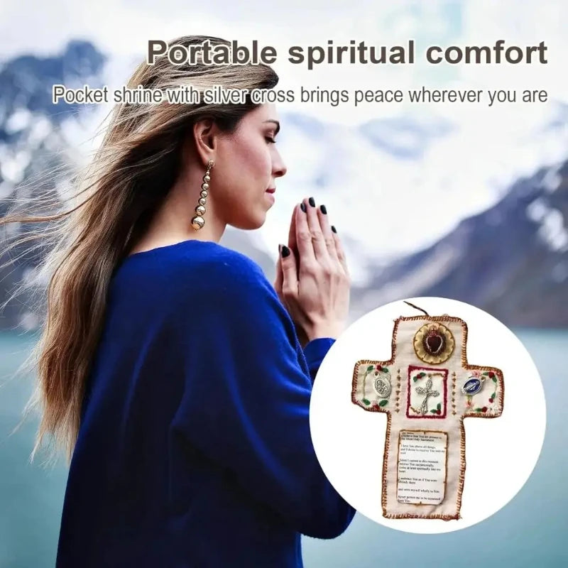 A woman wearing a blue sweater holds a silver cross prayer pocket decoration in her hand.