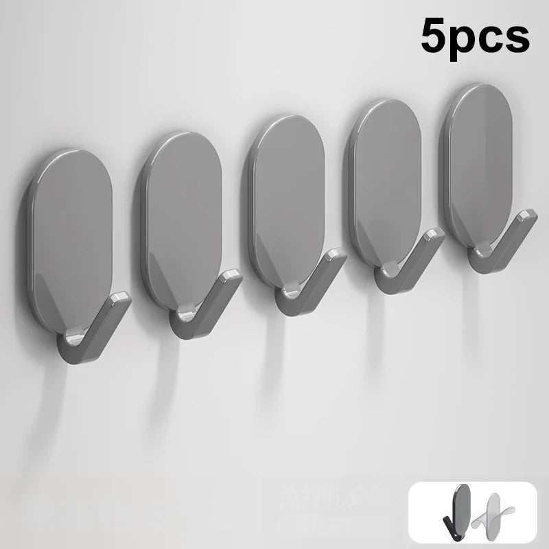 Five gray self-adhesive wall hooks displayed in a row against a white background.