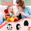 A woman is making a crochet penguin plush doll for a child, surrounded by colorful yarn and finished products.