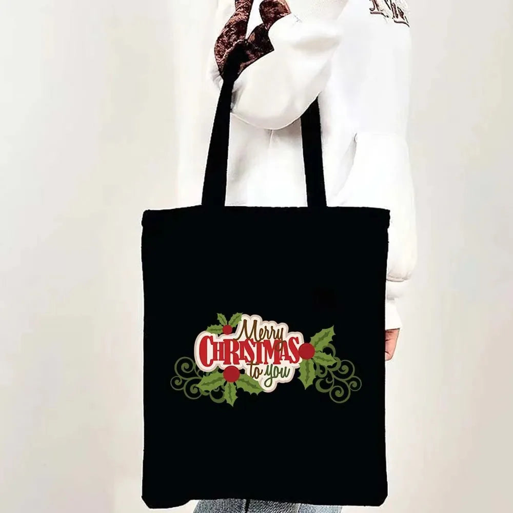 Black tote bag featuring a festive Christmas design with the text Merry Christmas to you
