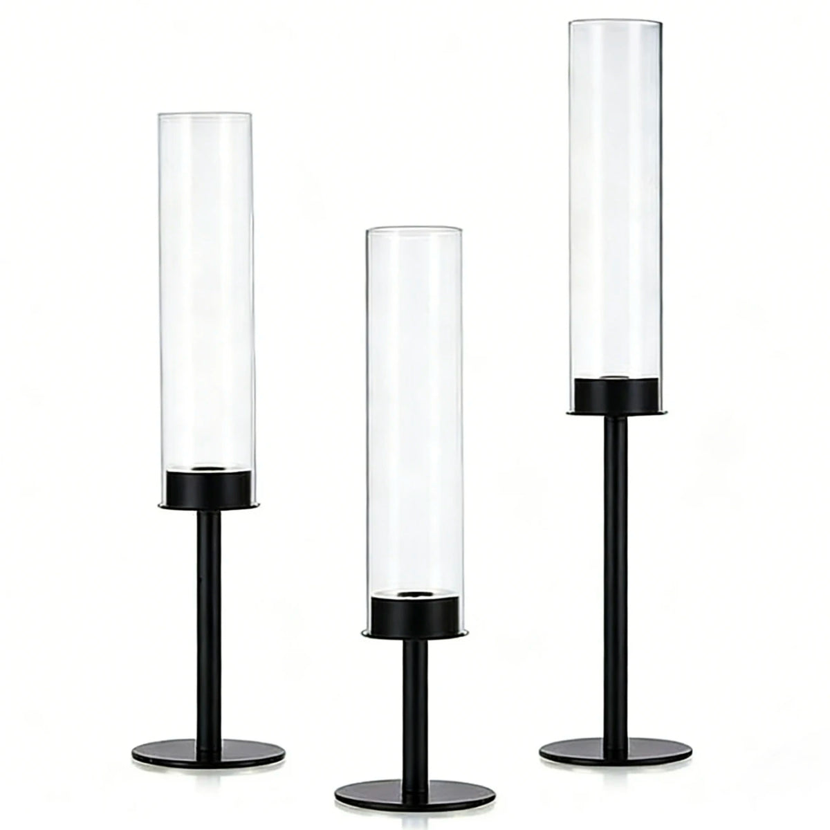A set of three clear glass hurricane candle holders with black bases