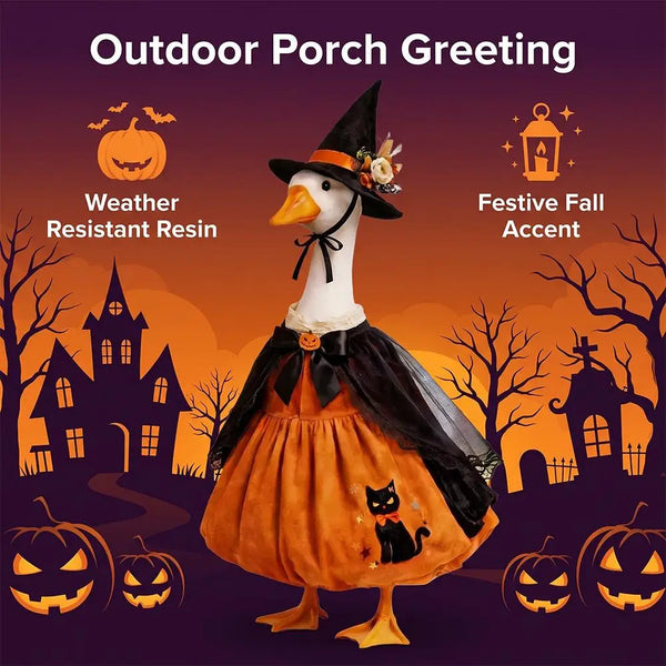A decorative ceramic goose figure wearing a witch hat and cape, set against an autumn background with pumpkins.