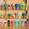 A collection of colorful handcrafted musical figurines featuring various animal shapes and expressions.