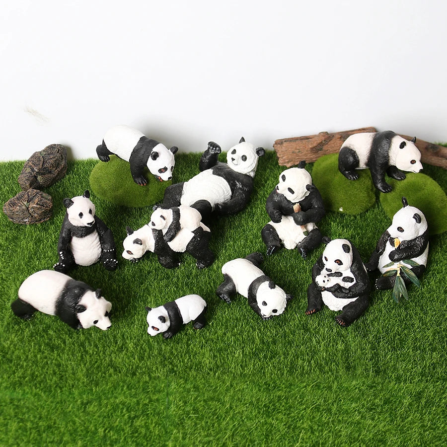 A set of realistic panda life cycle figurines in various poses and sizes resting on green moss.