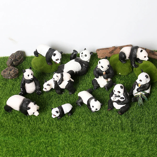 A set of realistic panda life cycle figurines in various poses and sizes resting on green moss.