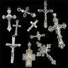 A collection of antique silver cross charms and pendants for jewelry making.