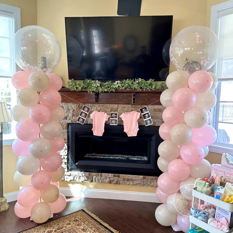 A display of pink and white balloons arranged in tall columns for a celebration or event.