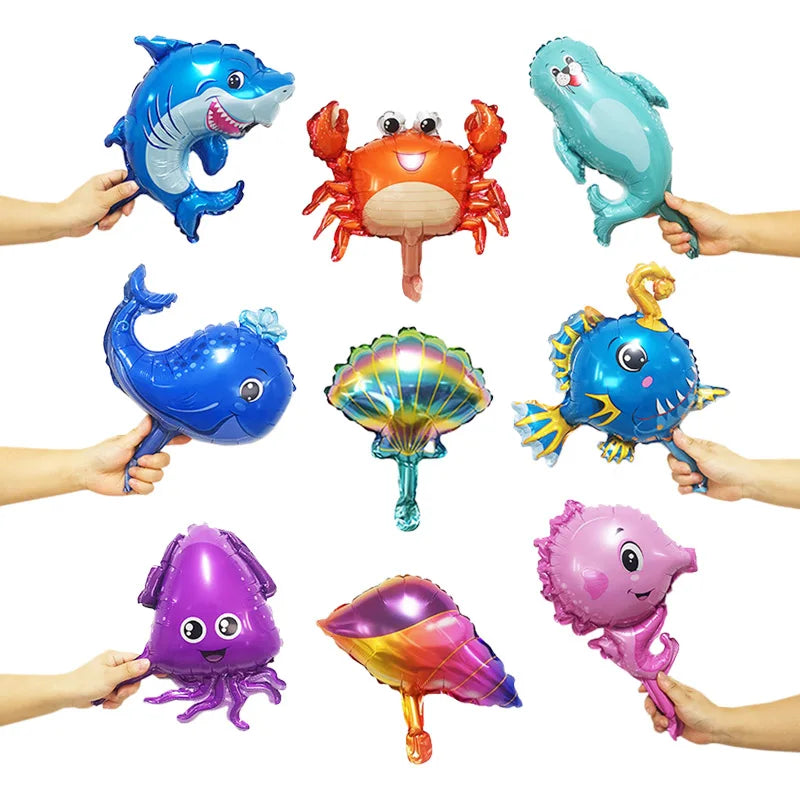 A set of foil balloons shaped like various ocean animals including a dolphin, crab, whale, and octopus.