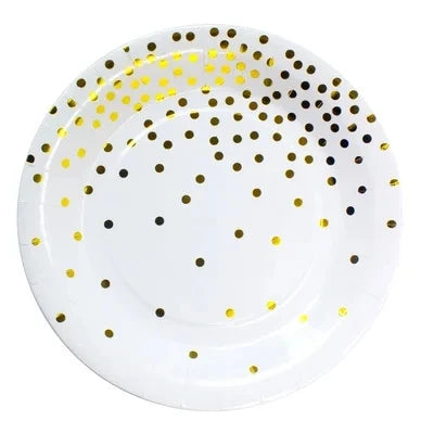 A white plate decorated with gold and black polka dots for a disposable party set.