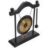 A black brass feng shui gong decor set featuring a large circular gong suspended by a wooden frame.
