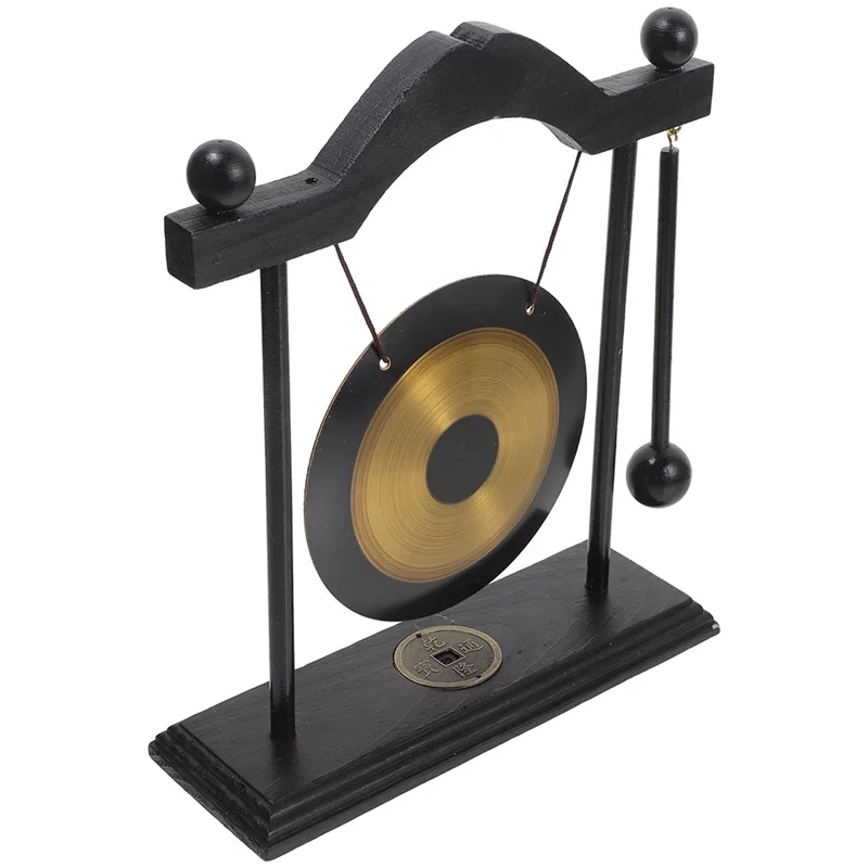 A black brass feng shui gong decor set featuring a large circular gong suspended by a wooden frame.