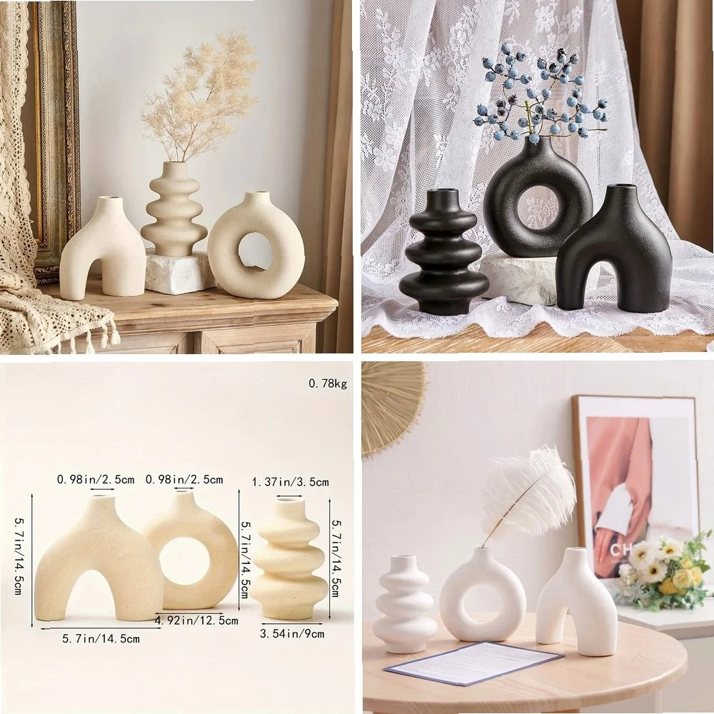 A set of natural and black ceramic vases displayed on a wooden surface with sheer white fabric backdrop.