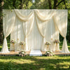 Elegant cream draped fabric backdrop for a wedding or party setup outdoors