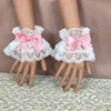 Pair of white ruffled lace wrist cuffs with pink satin bow accents