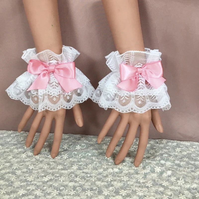 Pair of white ruffled lace wrist cuffs with pink satin bow accents