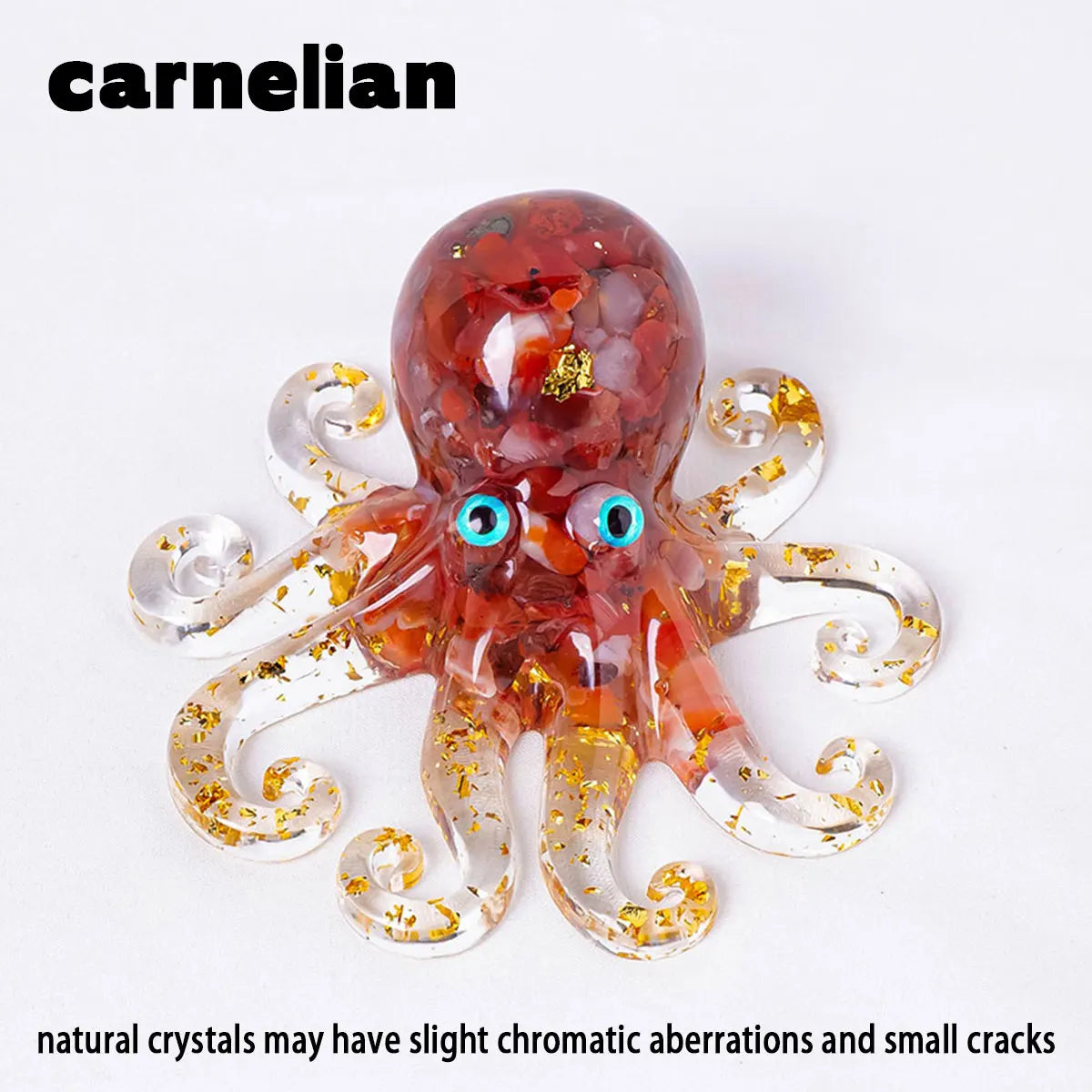 A translucent reddish-orange crystal octopus statue with blue eyes and gold inclusions.