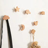 A collection of decorative wooden animal hooks, including a star, bear, and cloud, displayed against a white background.