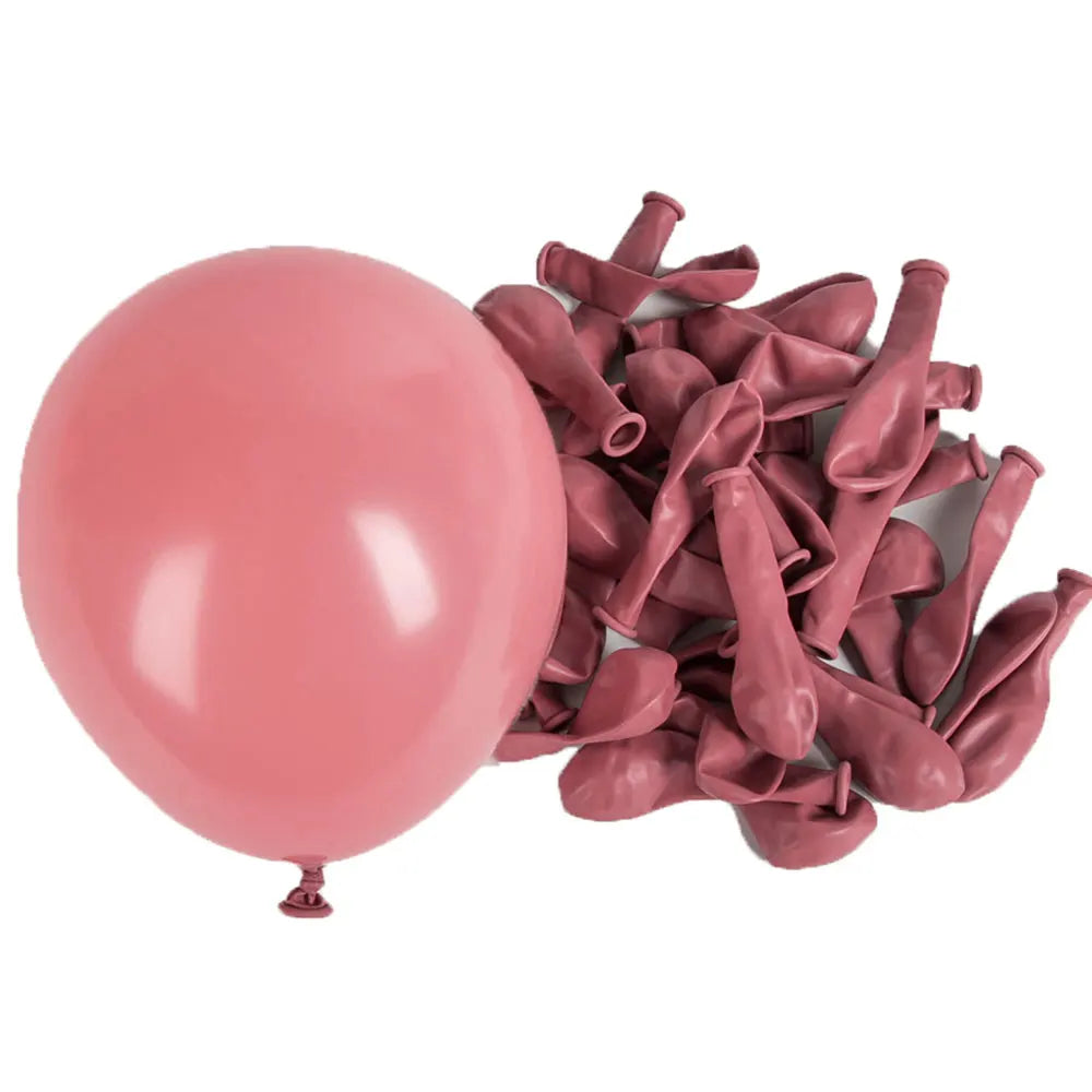 A bunch of pink latex balloons is shown next to a single large pink balloon.