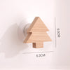 A light wood decorative arrow-shaped hook with dimensions 6.5cm by 6.3cm.