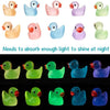A collection of luminous mini duck figurines in various pastel and bright colors.
