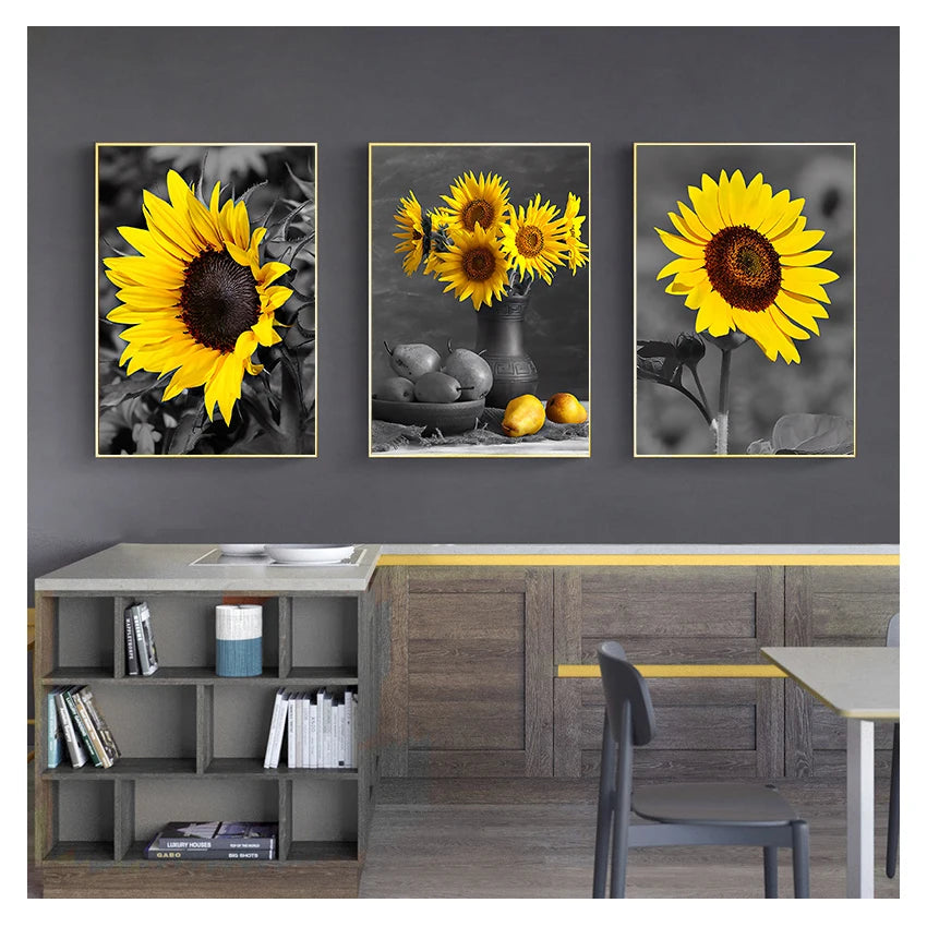 Three framed vintage sunflower canvas wall art prints displayed on a gray wall above wooden cabinetry.