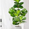 A large artificial ficus tree with vibrant green fiddle leaves potted in a gray cylindrical planter.
