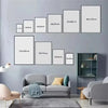 A modern scripture wall art set featuring a grid of framed prints in various sizes displayed on a gray wall.