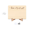 A light wood photo frame with cursive text that reads love at first sight, featuring a ribbon for a pregnancy announcement.