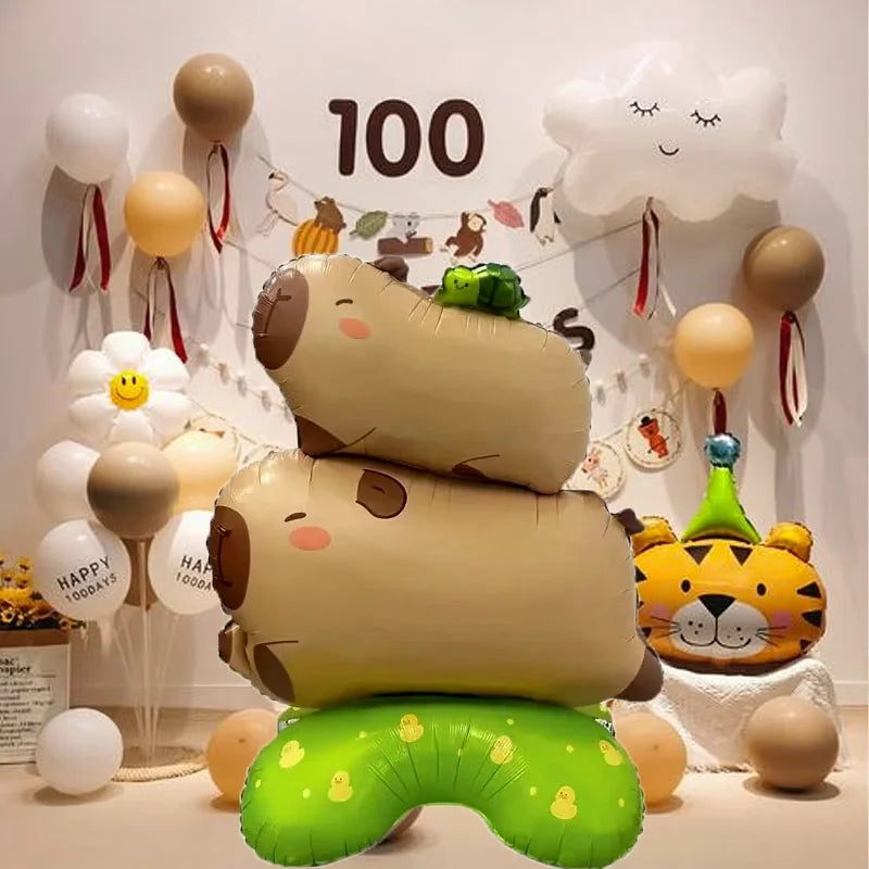 A group of foil balloons shaped like a turtle and capybara are displayed against a white background.