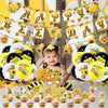 A collection of yellow and gold bee-themed latex balloons and cupcake decorations for a birthday party