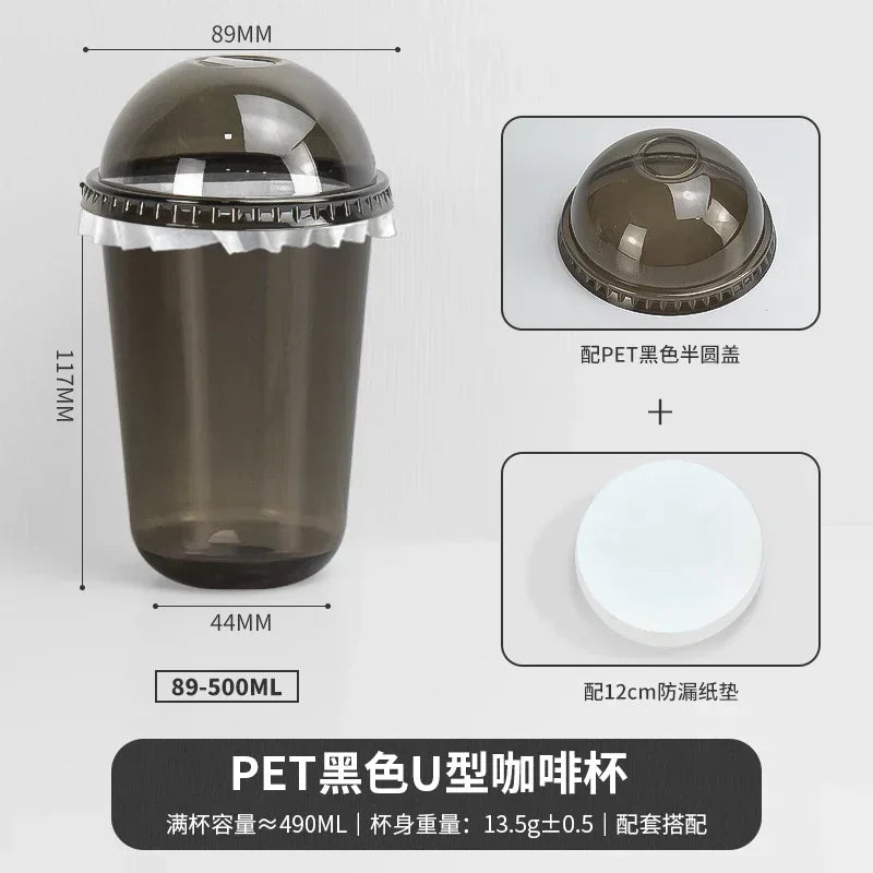 A black disposable U-shaped coffee cup with a clear lid and a white base shown in various views.