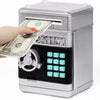 A hand inserts a stack of US dollar bills into a silver combination lock piggy bank.