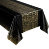 Black and gold polka dot disposable tablecloth with a satin finish