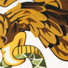 Close-up of a golden eagle head and wing design on a fabric, featuring brown and gold colors.