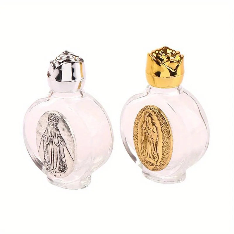 A pair of glass bottles, one silver and one gold, shaped like religious sculptures for holy water.
