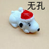 A white ceramic dog pendant with a red Santa hat and black nose, used for jewelry making.