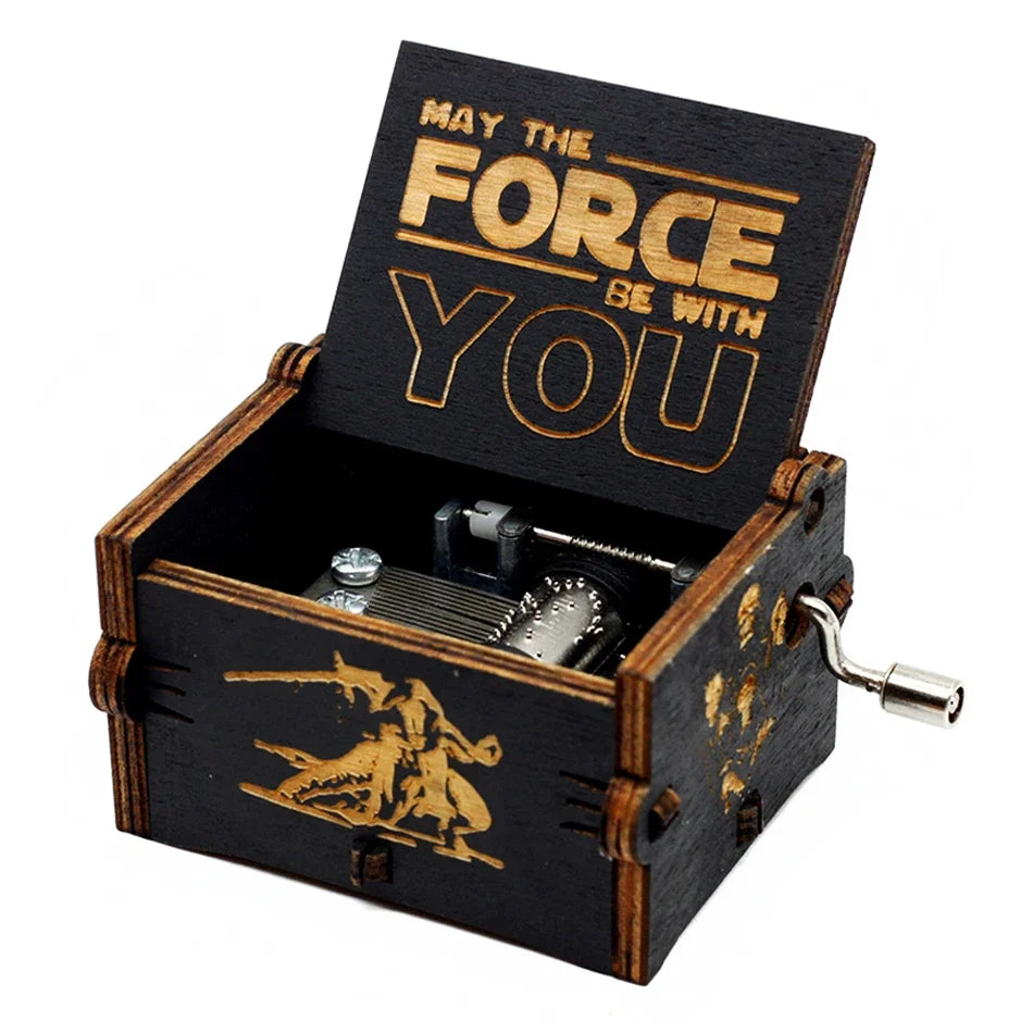A carved wooden music box with an open lid featuring the text May The Force Be With You