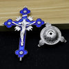 Antique-style crucifix figurine with a silver cross and blue enamel on a dark background.