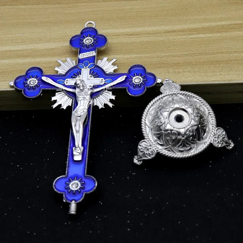 Antique-style crucifix figurine with a silver cross and blue enamel on a dark background.