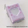 A pink mini photo card album binder with a heart-shaped clear window and decorative elements.