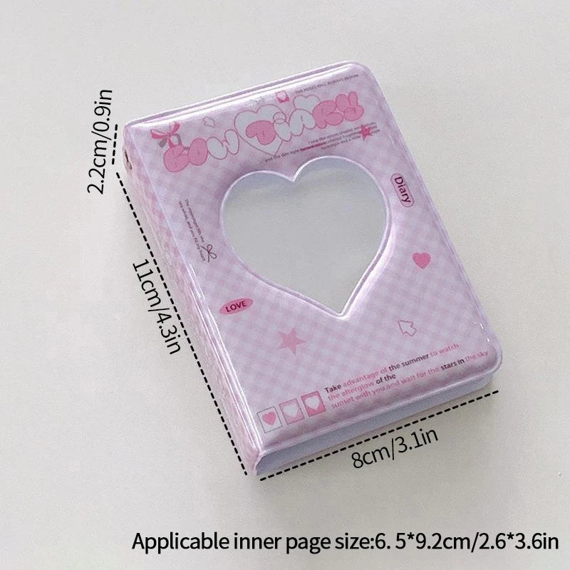 A pink mini photo card album binder with a heart-shaped clear window and decorative elements.
