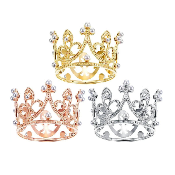 A set of three elegant crown cake toppers in gold, rose gold, and silver with pearl accents.