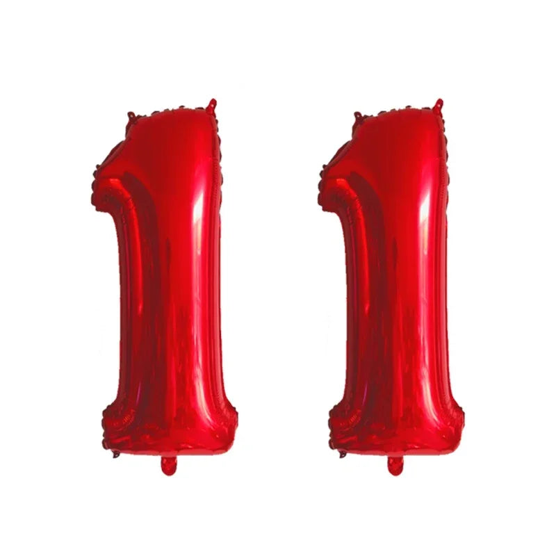 Two shiny red foil number balloons shaped like the number one