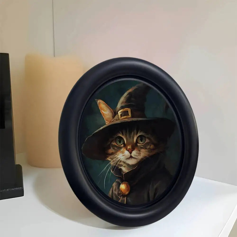 A round black photo frame featuring a dark portrait of a cat wearing a wide-brimmed hat.
