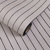 Roll of self-adhesive 3D wood grain wall panels showing the textured surface and black edge.